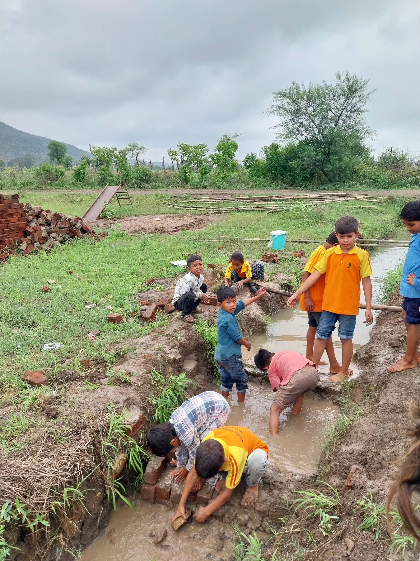Children and community gathered on the school farm